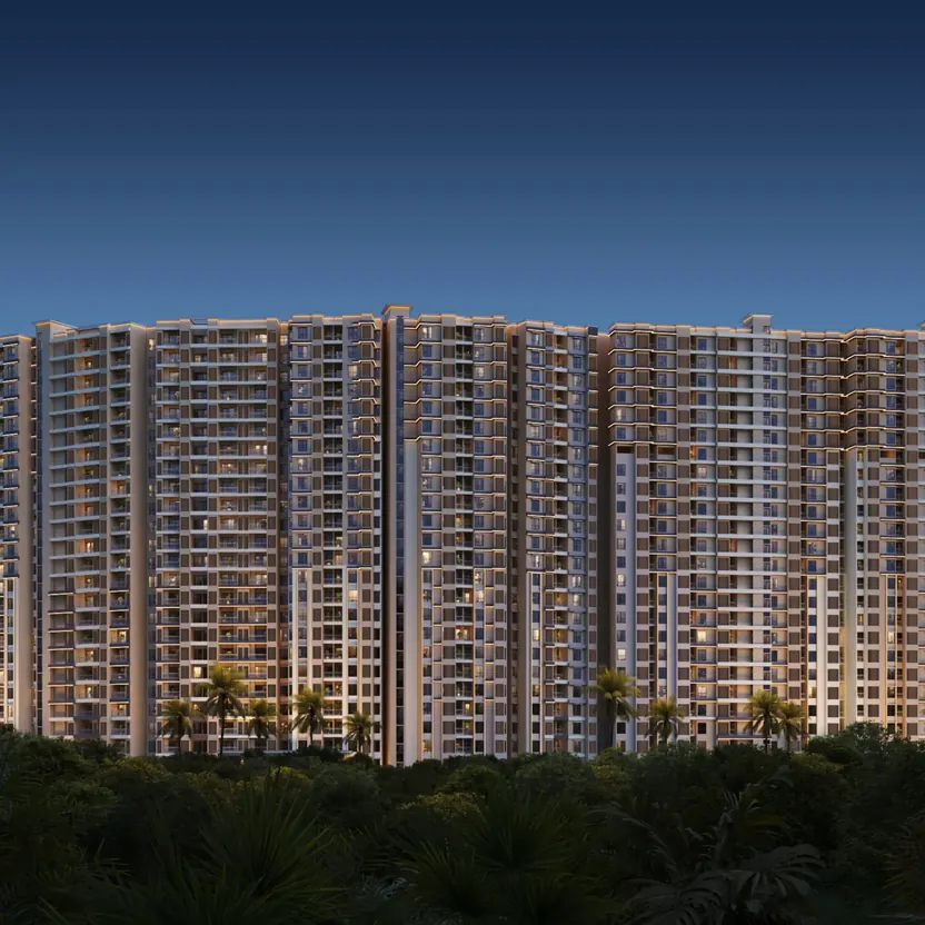 The towers lit at dusk above a band of trees